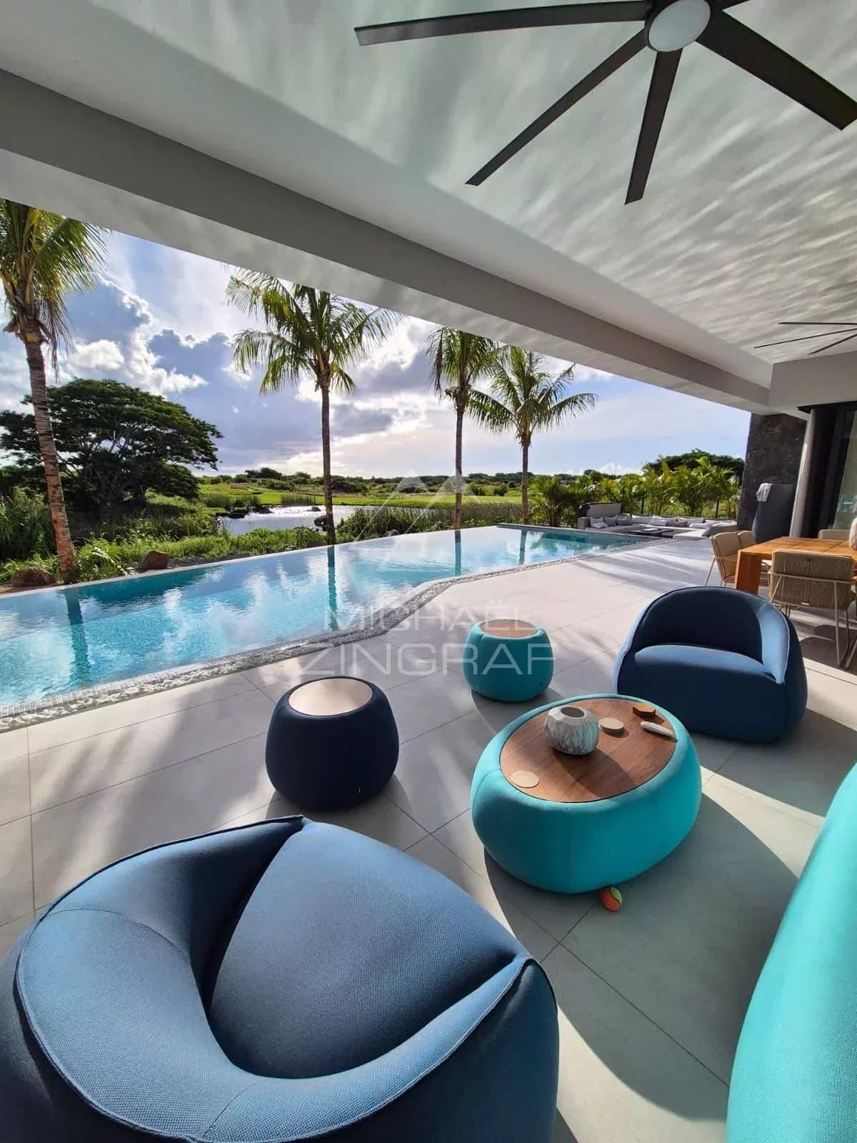 View from the terrace of a contemporary villa with swimming pool and modern furniture in Mon Choisy Golf, Grand Baie.