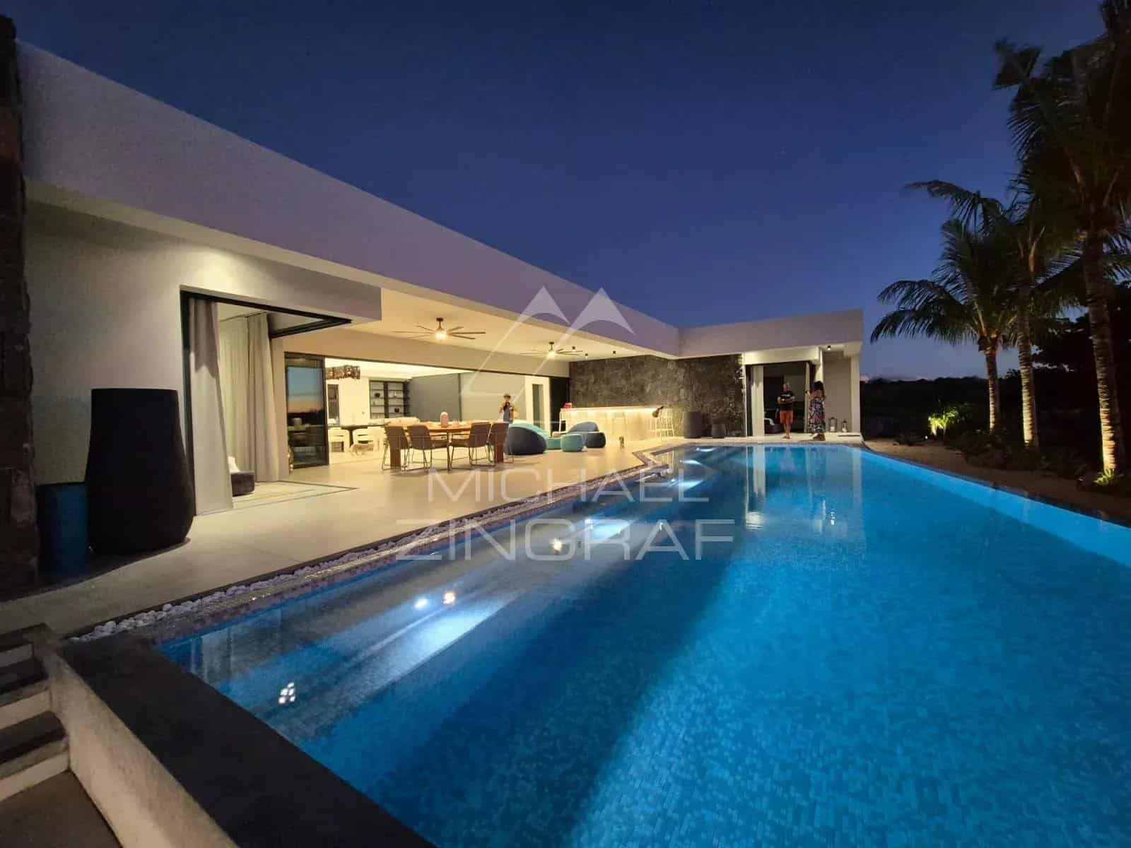 Contemporary villa with pool at dusk, Mon Choisy Golf, Grand Baie.