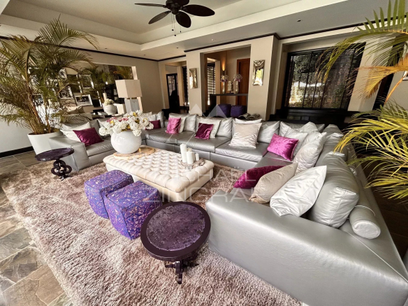 Interior of a villa in Beau Champ with an elegant living room, modern sofa and glamorous decor.
