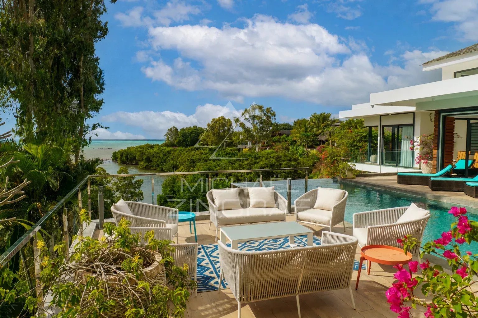 Terrasse d'une villa avec piscine, meubles de jardin et vue sur la nature à Haute Rive.