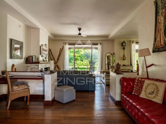 Interior of a spacious villa with living room and garden view in Bel Ombre, Mauritius.
