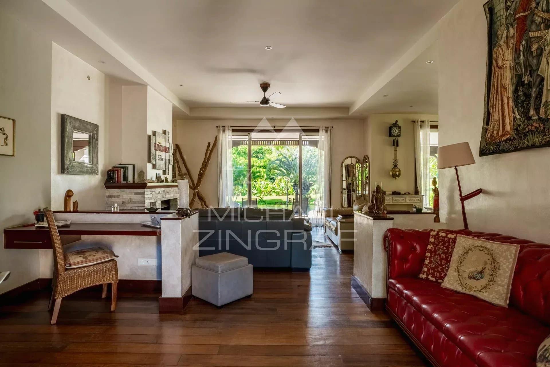 Interior of a spacious villa with living room and garden view in Bel Ombre, Mauritius.
