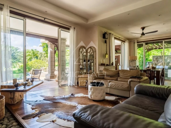 Interior of a spacious villa with living room and garden view in Bel Ombre, Mauritius.