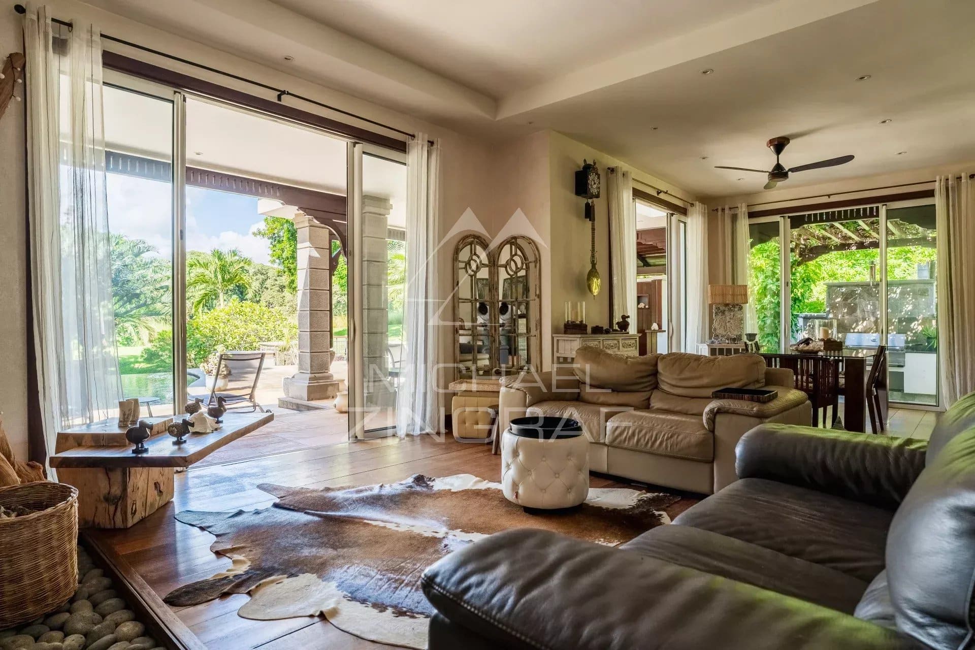 Interior of a spacious villa with living room and garden view in Bel Ombre, Mauritius.
