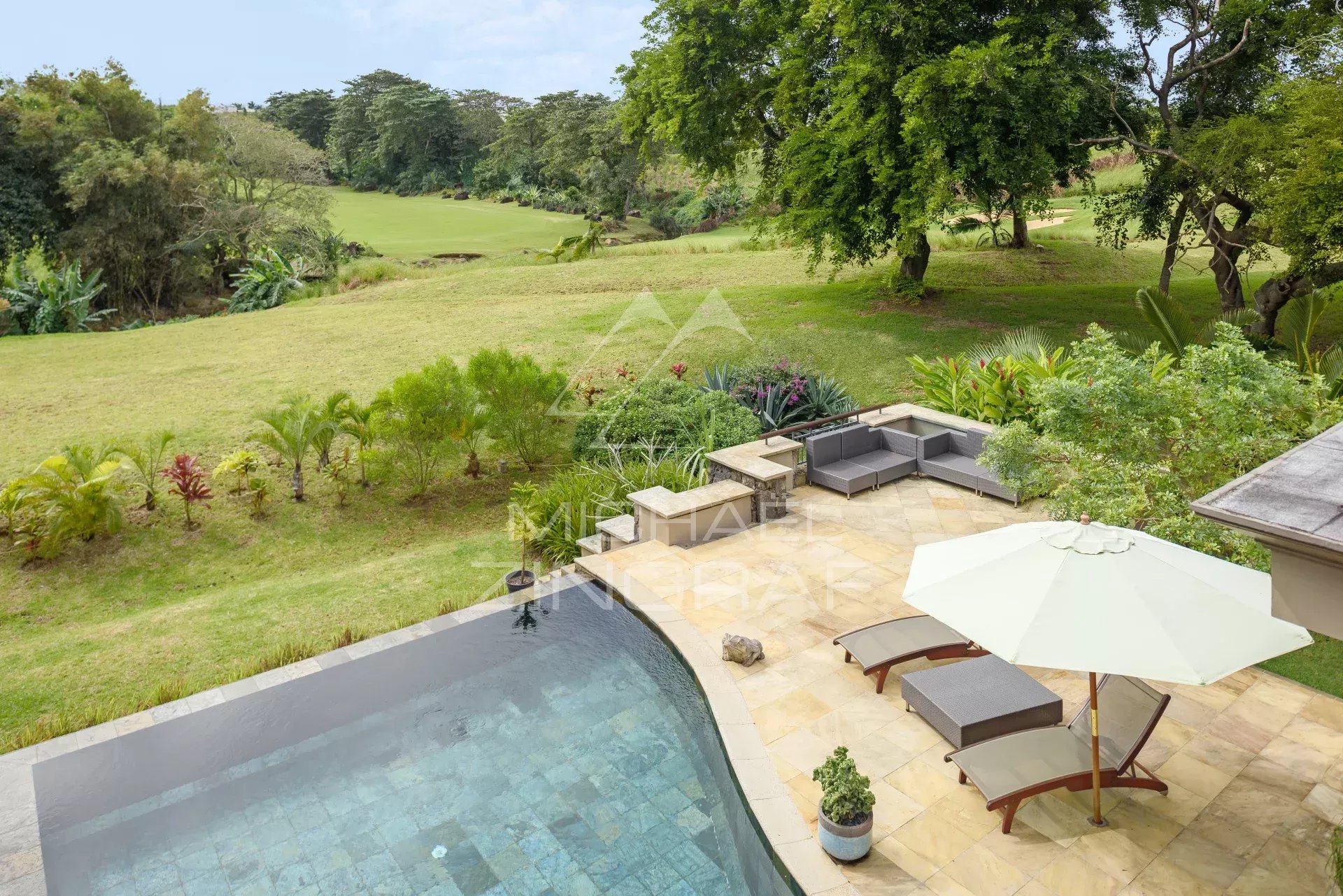View of a villa with swimming pool and outdoor furniture on a golf course in Bel Ombre, Mauritius.