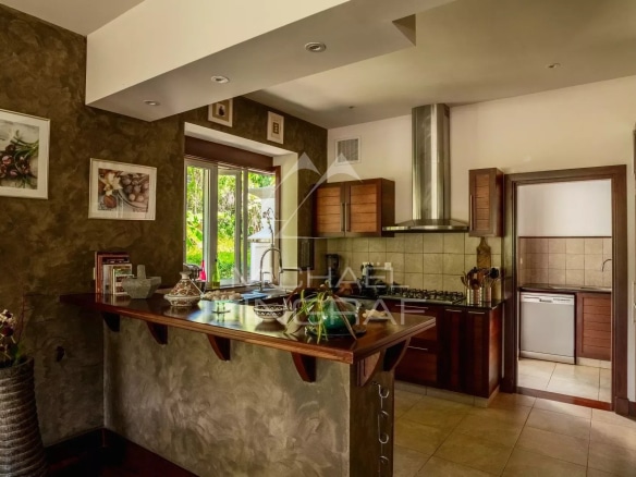 Spacious kitchen in a villa in Bel Ombre, Mauritius, with modern features and a bar.