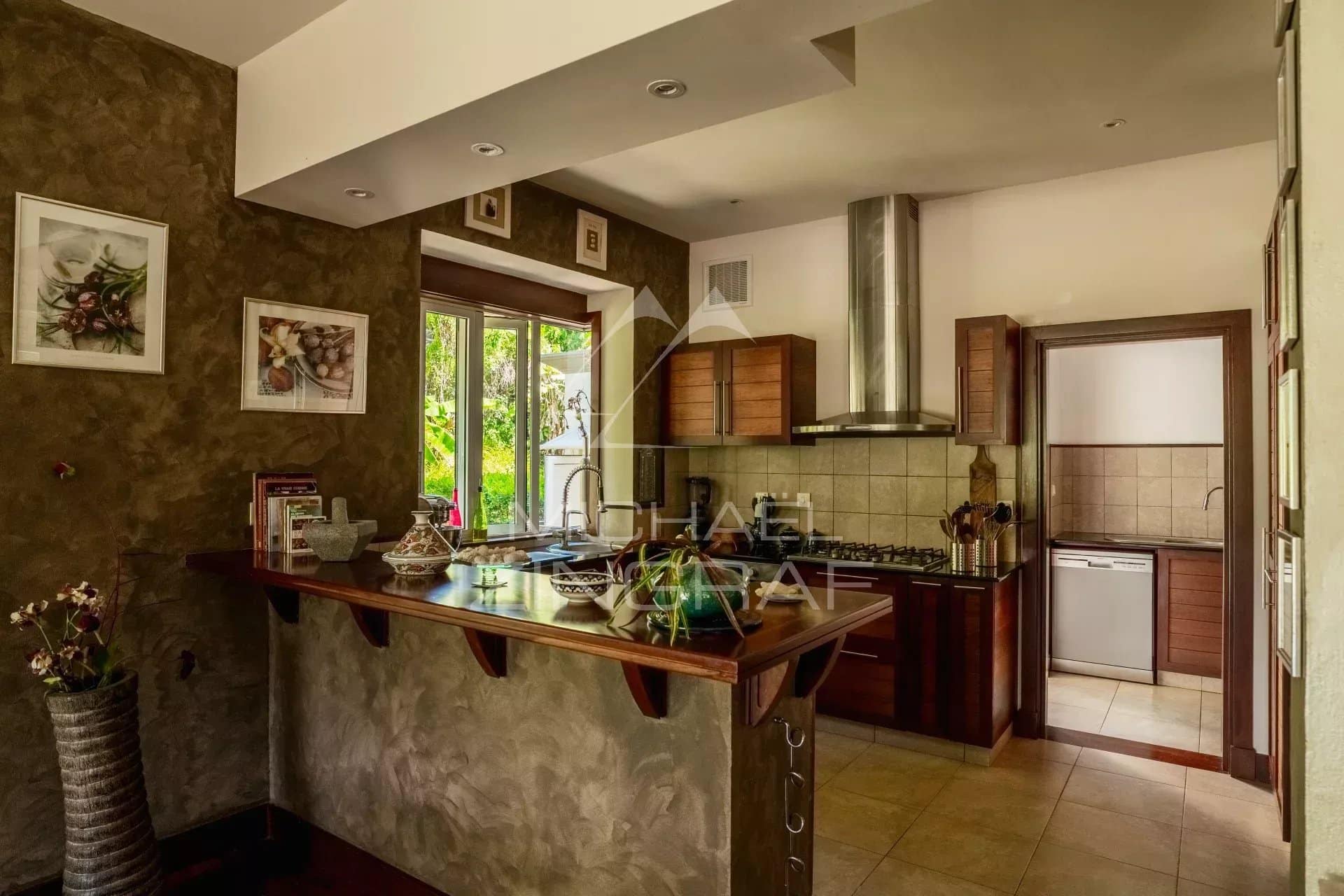 Spacious kitchen in a villa in Bel Ombre, Mauritius, with modern features and a bar.