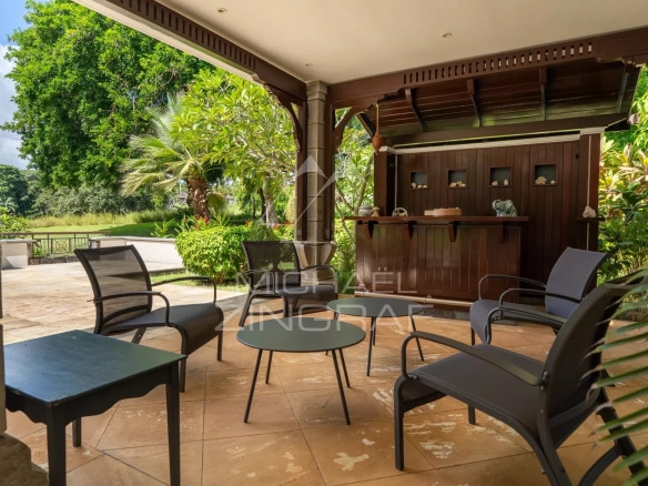 Terrace of a villa on a golf course in Bel Ombre, Mauritius, with garden furniture.