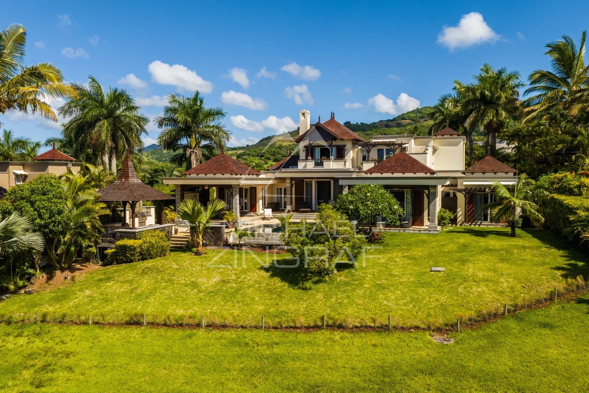 Elegant two-story villa with ocean views and a lush garden in Bel Ombre, Mauritius.