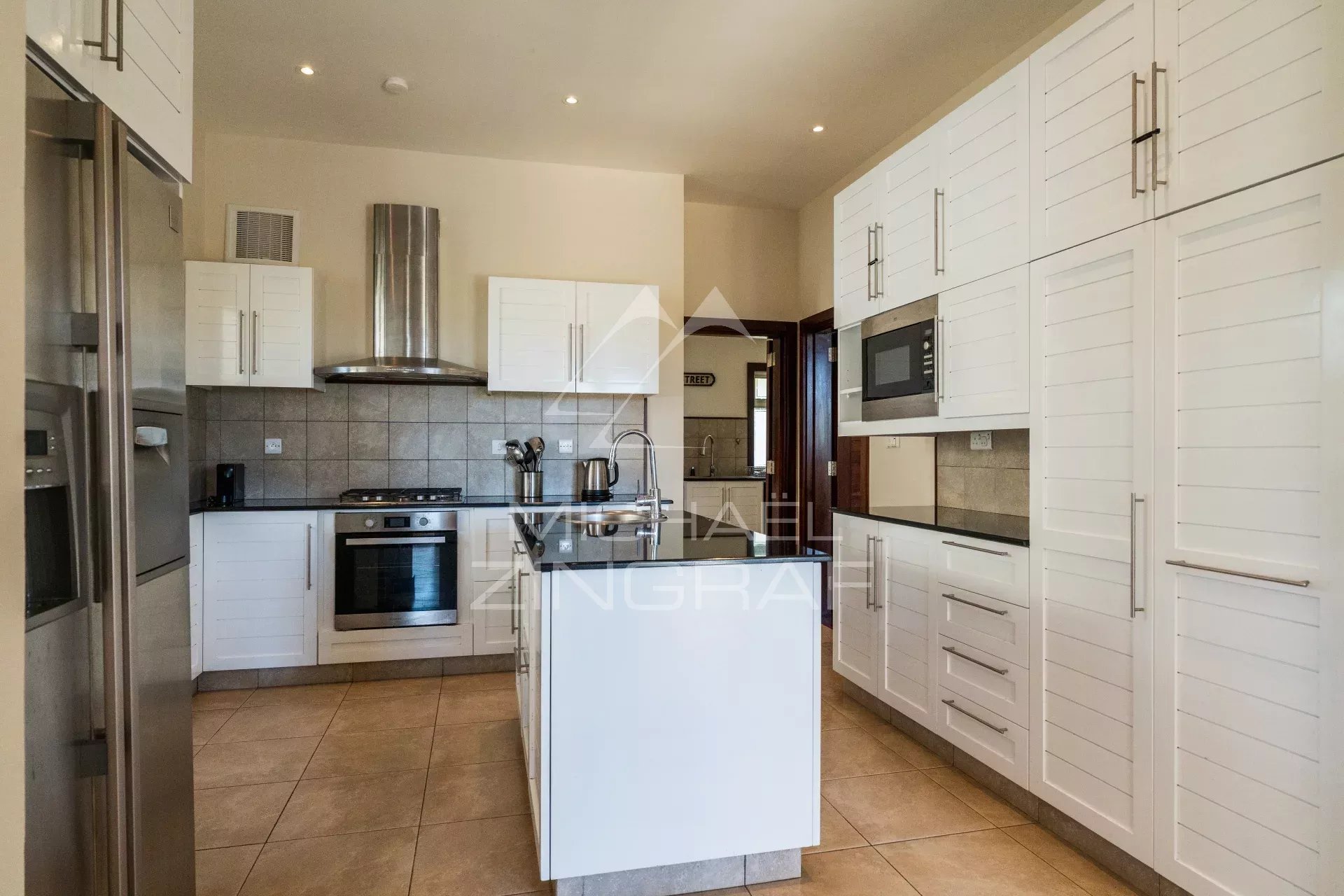 Modern and bright kitchen in a villa in Bel Ombre, Mauritius, with modern appliances.