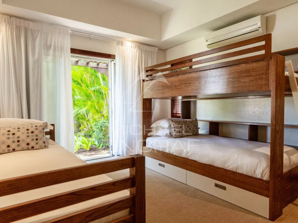 Room in a villa in Bel Ombre with bunk beds and garden view.