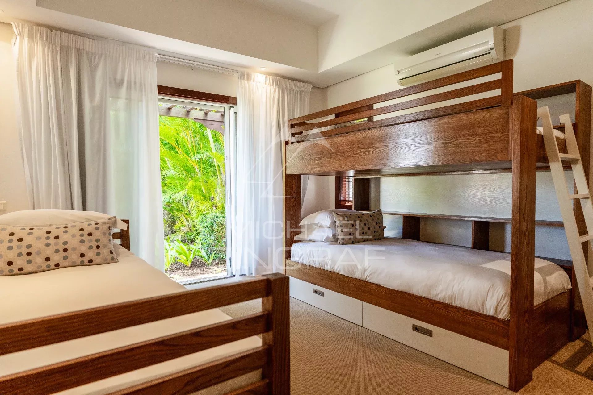 Room in a villa in Bel Ombre with bunk beds and garden view.