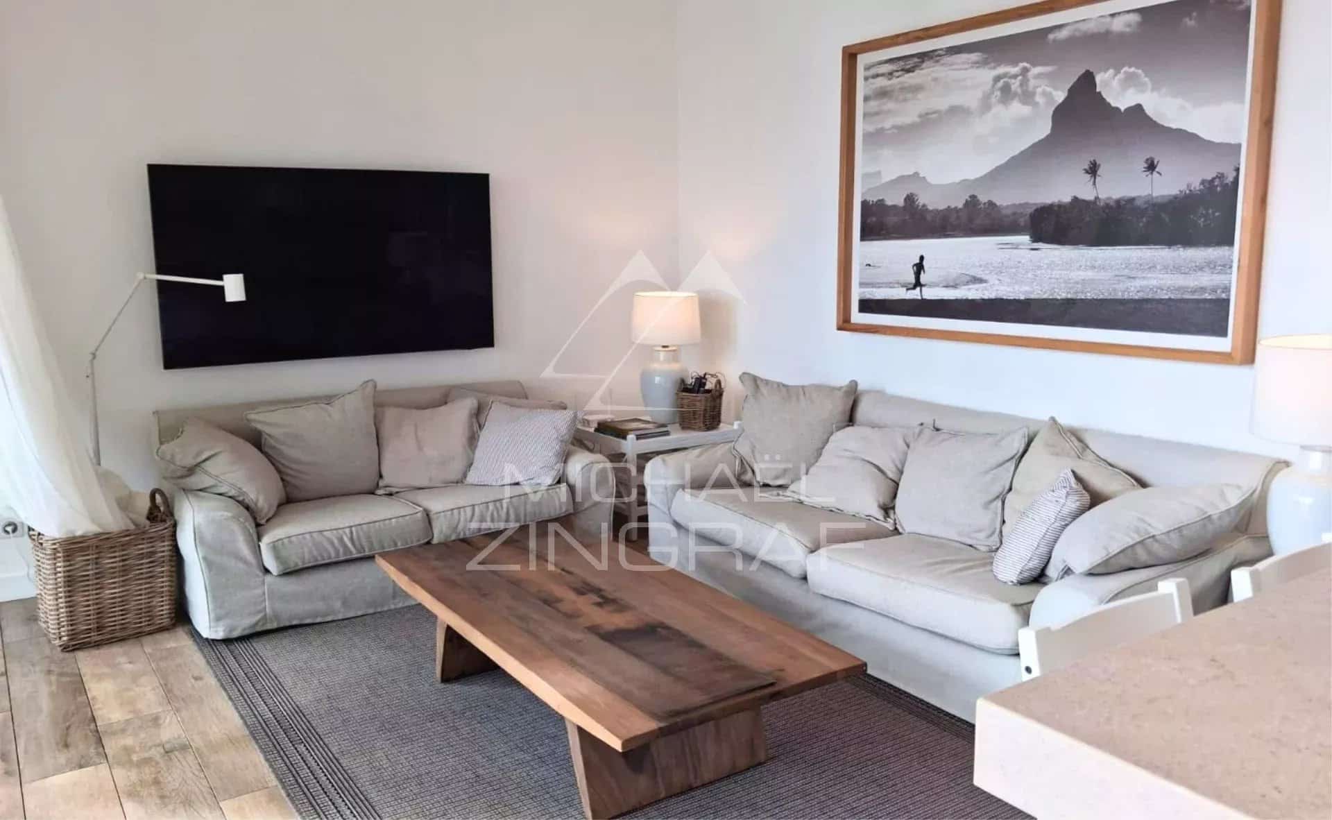 Living room of an apartment with sofa and coffee table, decorated in a modern style.