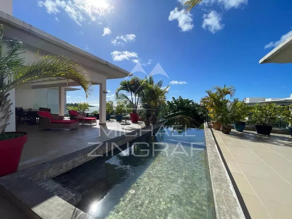 Penthouse with pool and sea view in Haute Rive, surrounded by greenery.
