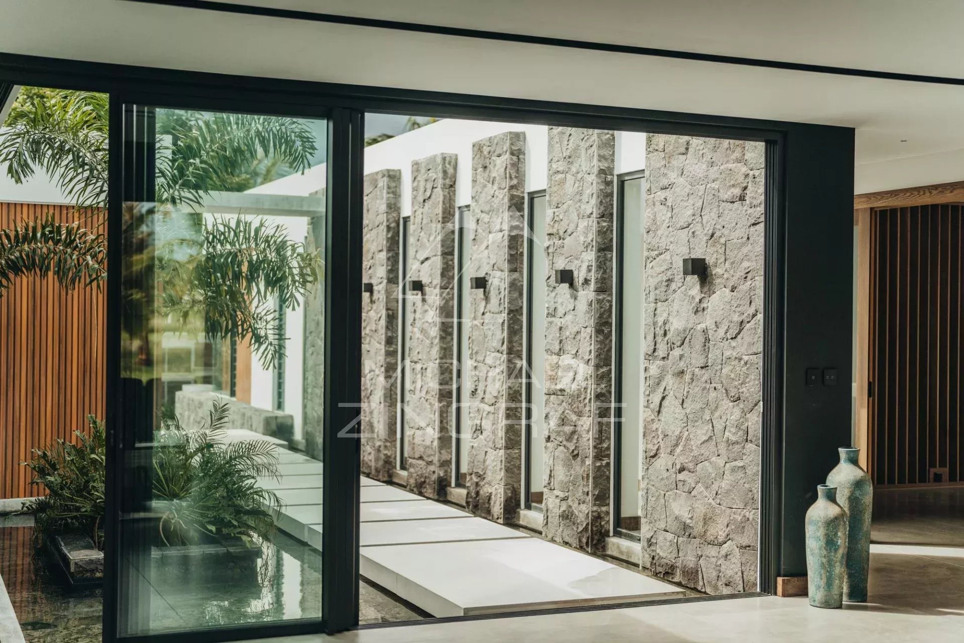 Interior of a contemporary villa Modern interior of a villa with stone walls and large bay windows.