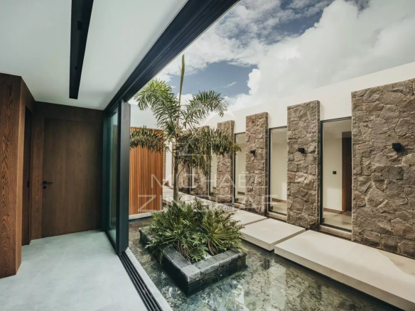 Modern interior of a villa with garden and stone walls in Haute Rive.