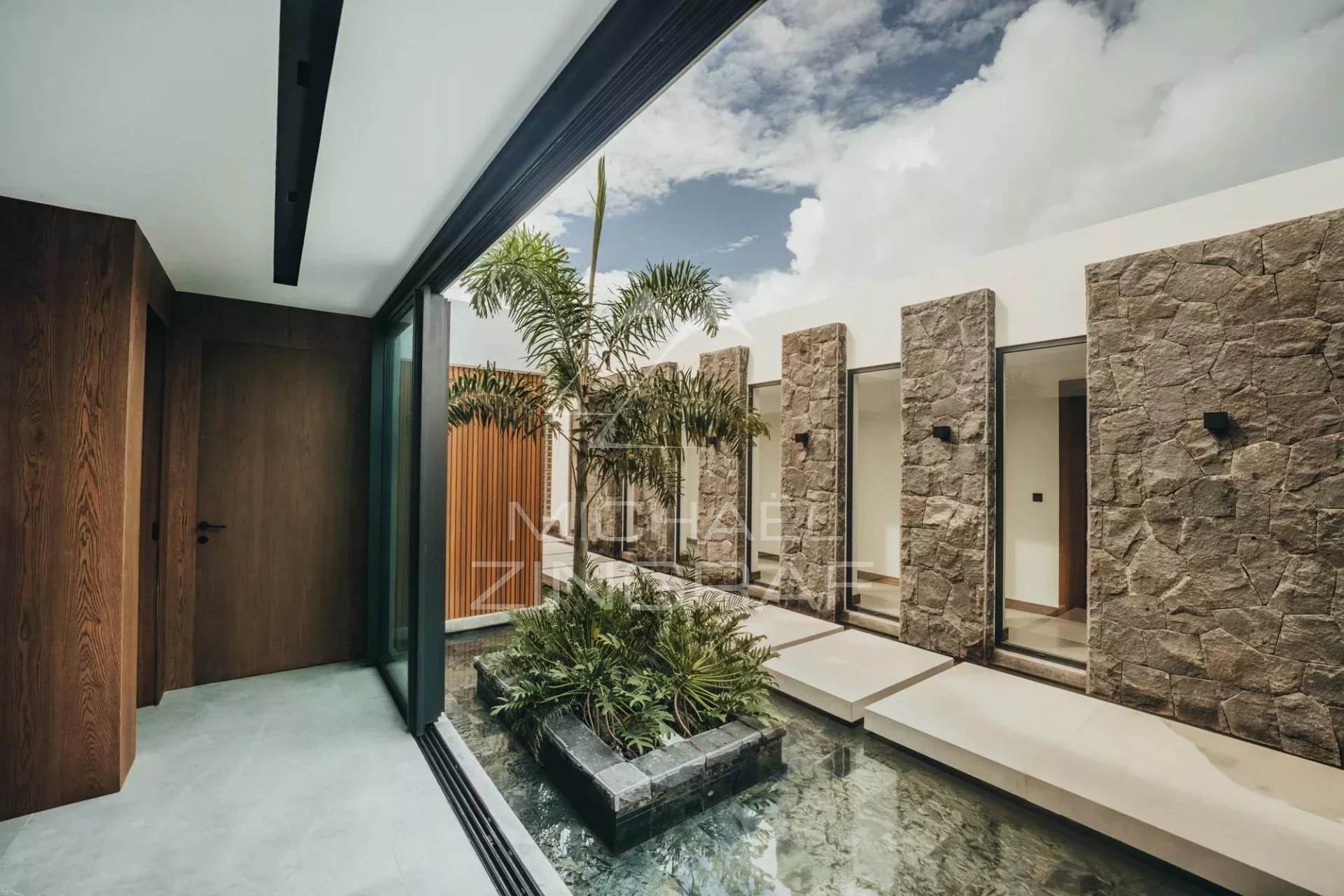 Modern villa in Haute Rive Modern interior of a villa with garden and stone walls in Haute Rive.