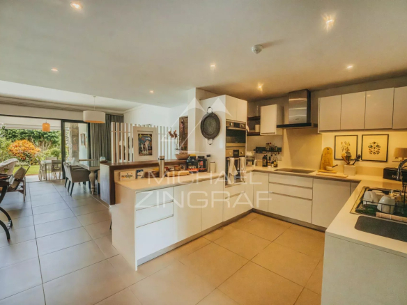 Modern kitchen in a 3-bedroom apartment with bright living space and access to a garden.