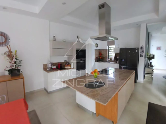 Interior of a modern villa in Pereybère with open kitchen and bright living room.