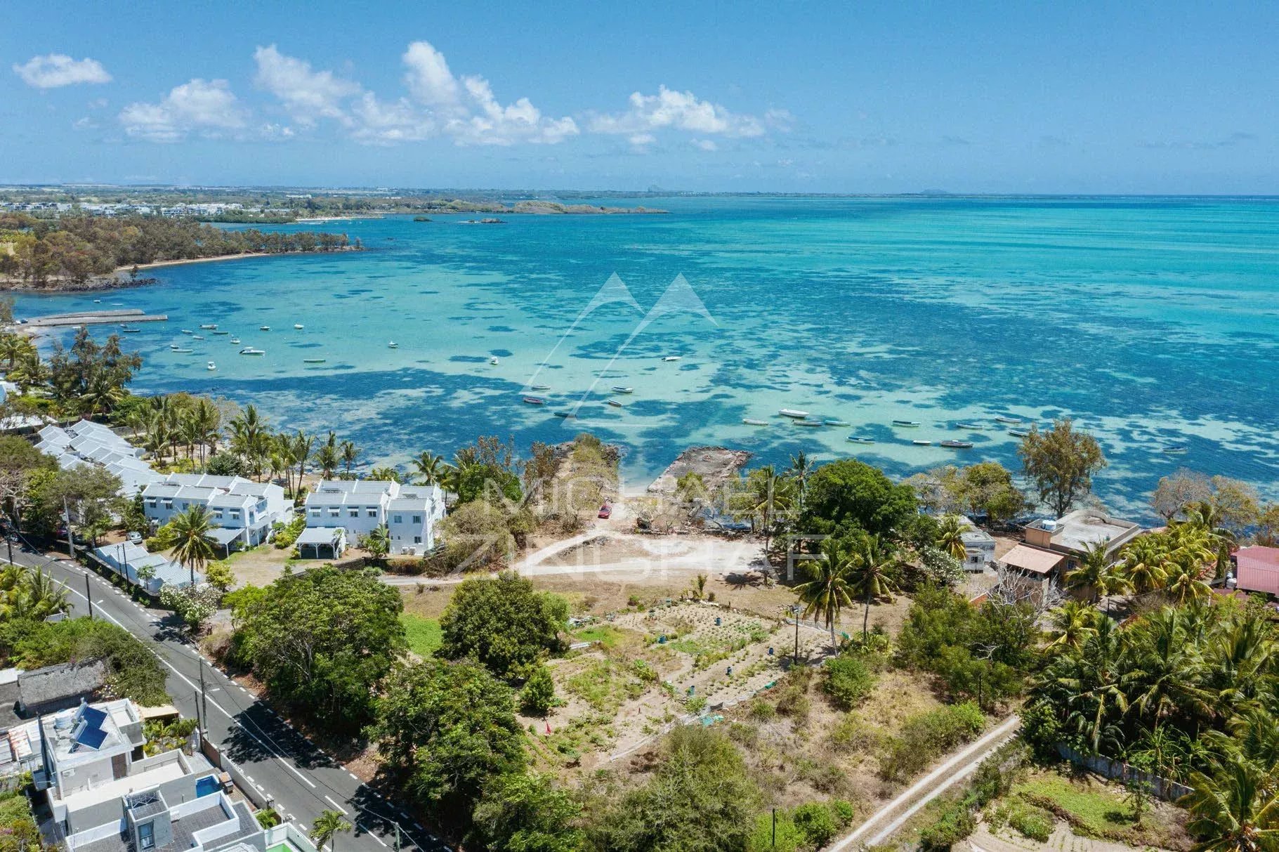 Penthouse with lagoon view in Roches Noires Panoramic view of the turquoise lagoon and the coast of Roches Noires, Mauritius.
