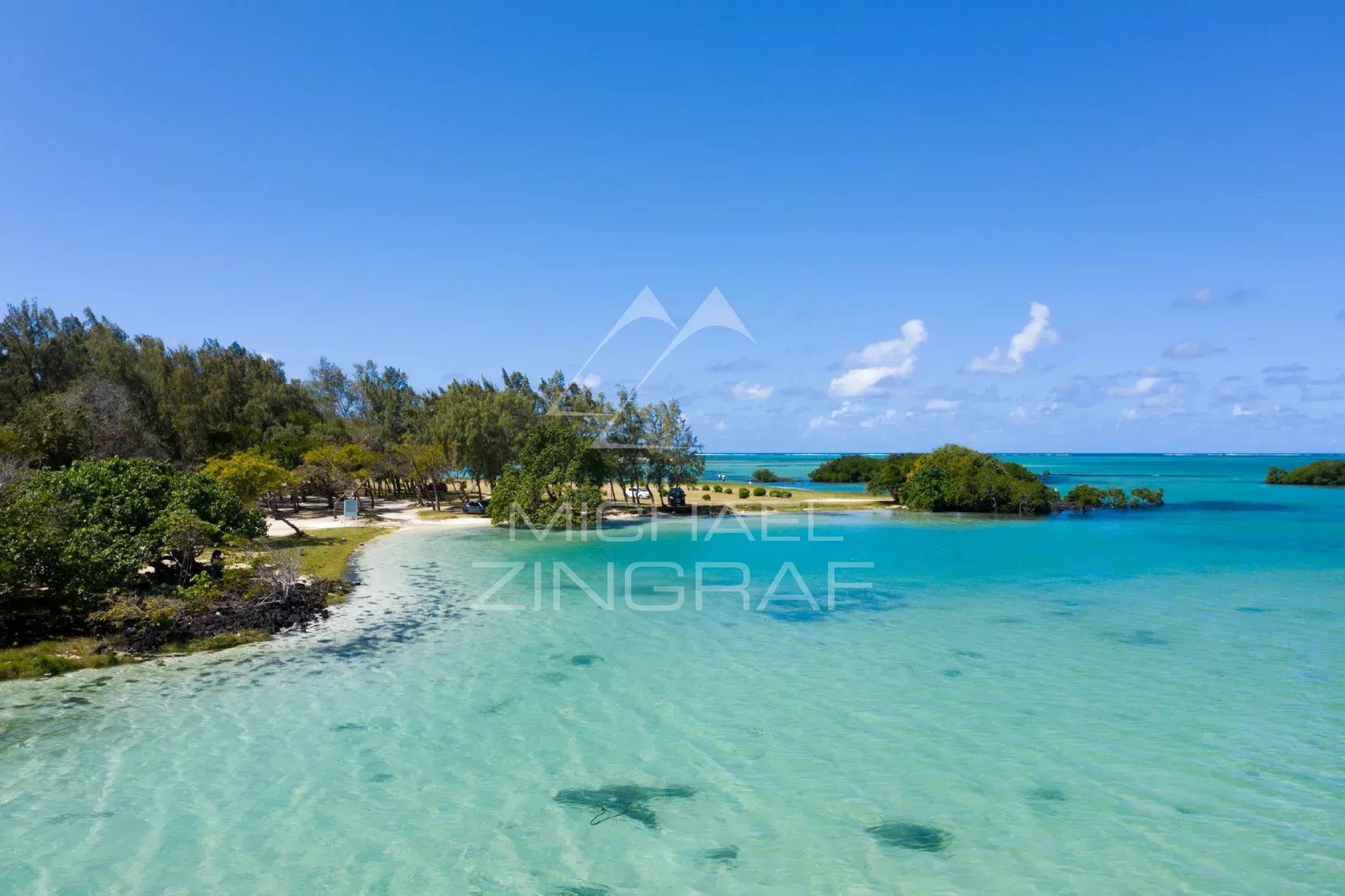 Black Rocks Beach, Mauritius Black Rocks Beach with turquoise waters and vegetation in the background.
