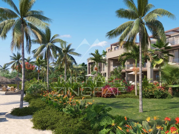 View from a penthouse in Roches Noires, surrounded by palm trees and flower gardens, near the beach.