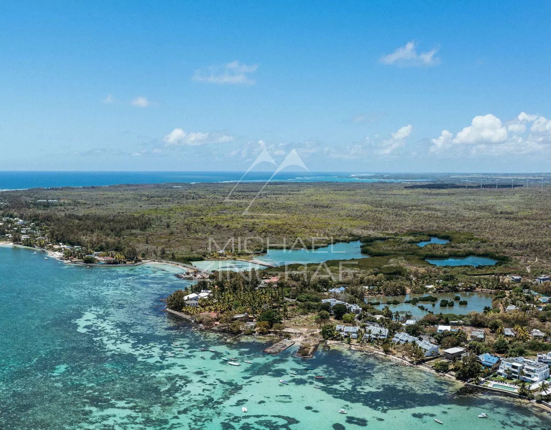 Aerial view of Roches Noires Aerial view of Roches Noires with lagoon and lush vegetation.