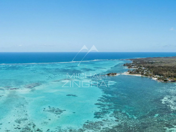 Aerial view of Roches Noires with turquoise sea and coastline.
