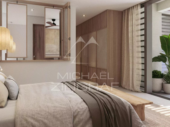 Bedroom in a modern apartment with bed, minimalist decor and natural light in Roches Noires.