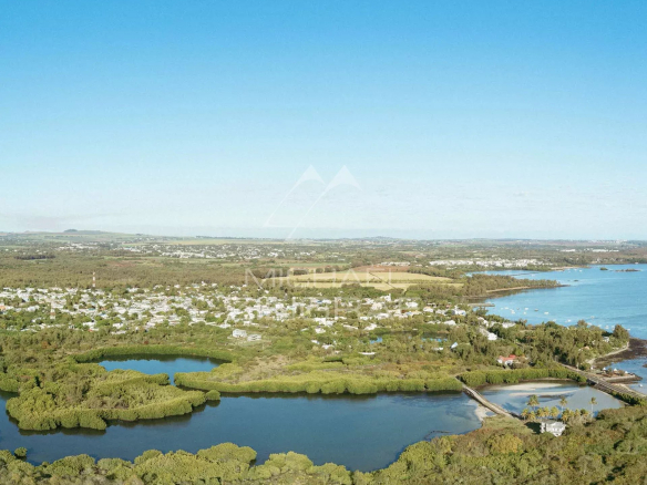 Aerial view of Roches Noires with lagoons and lush green nature.