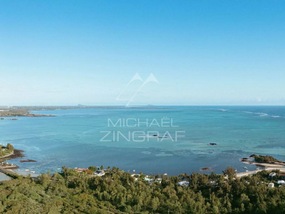 Panoramic ocean view at Roches Noires, with verdant landscapes in the foreground.