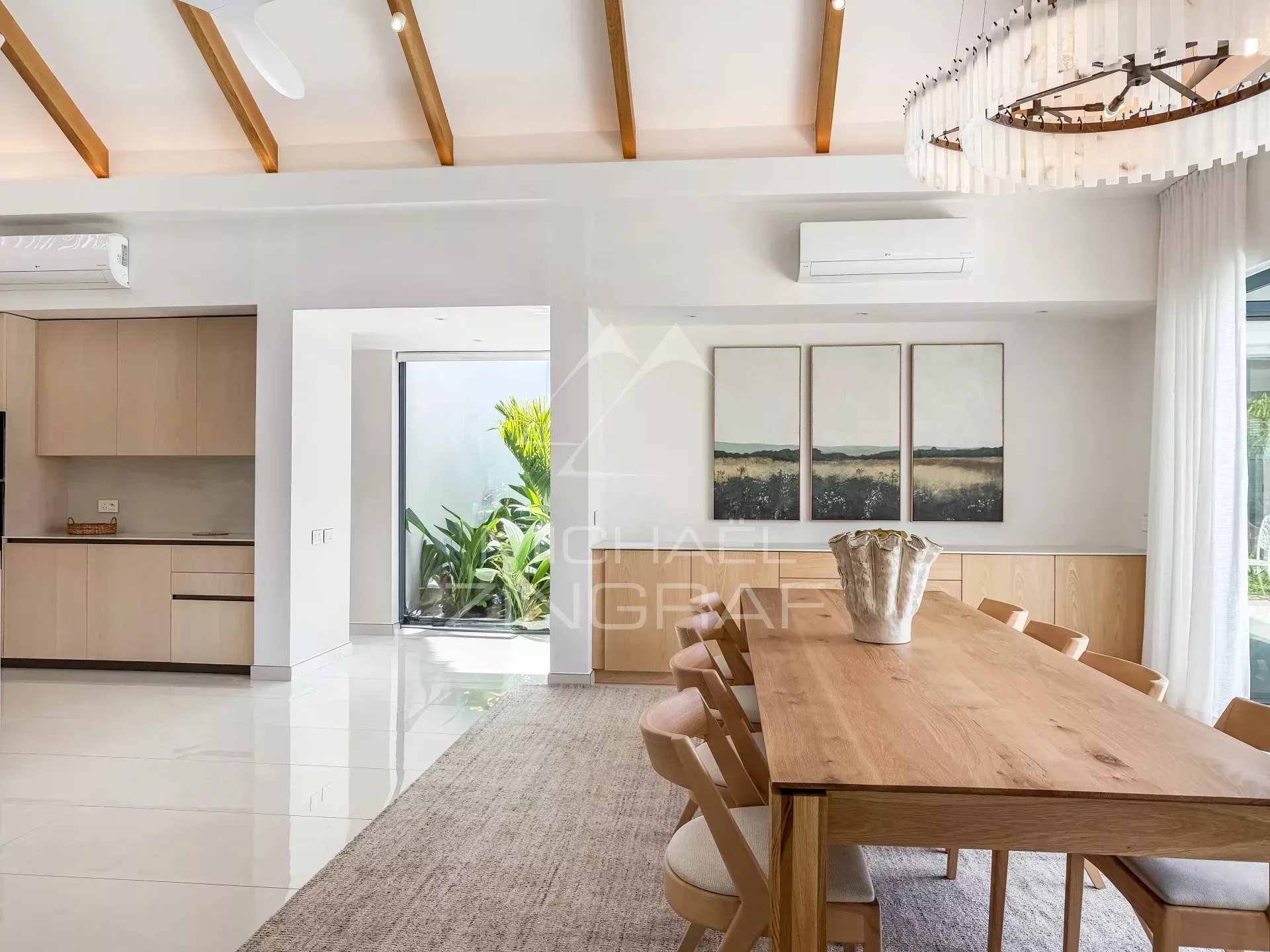 Intérieur de la villa au Mont Choisy Golf Estate Intérieur d'une villa moderne avec salle à manger et accès à un jardin.