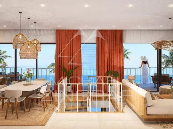 Intérieur d'une villa bioclimatique avec salon, salle à manger et vue sur la mer.
