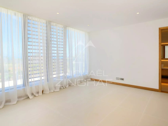 Intérieur d'une villa neuve avec de grandes fenêtres et un sol en carrelage.