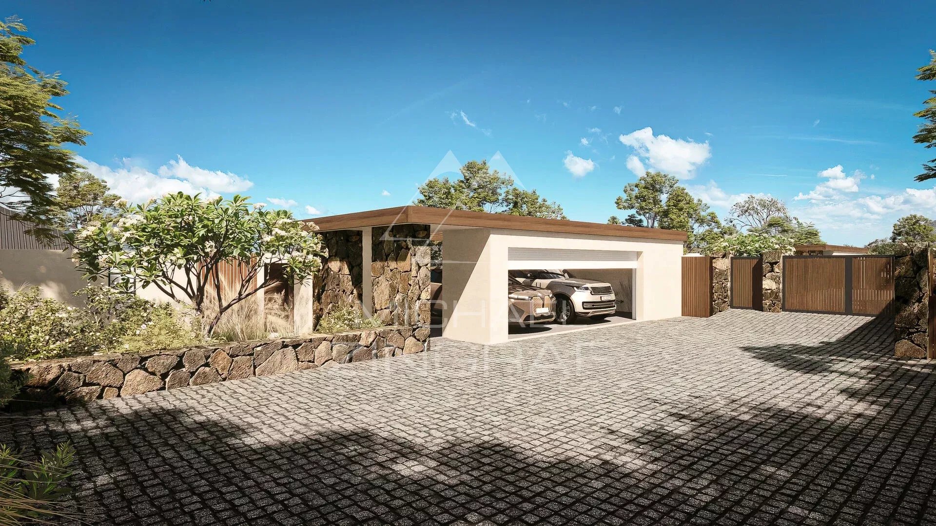 Villa de luxe à Rivière Noire Entrée d'une villa de luxe avec garage et allée pavée, entourée de verdure.