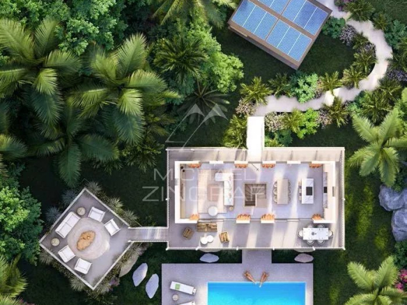 Aerial view of a bioclimatic villa with private pool surrounded by greenery in Baie du Cap.