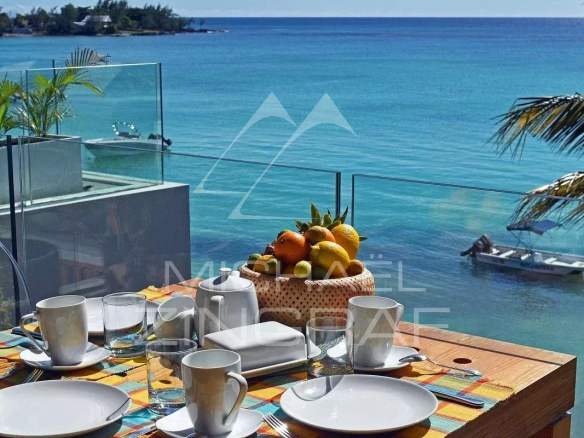 Terrace of an apartment with sea view, table set for breakfast in Pereybere.