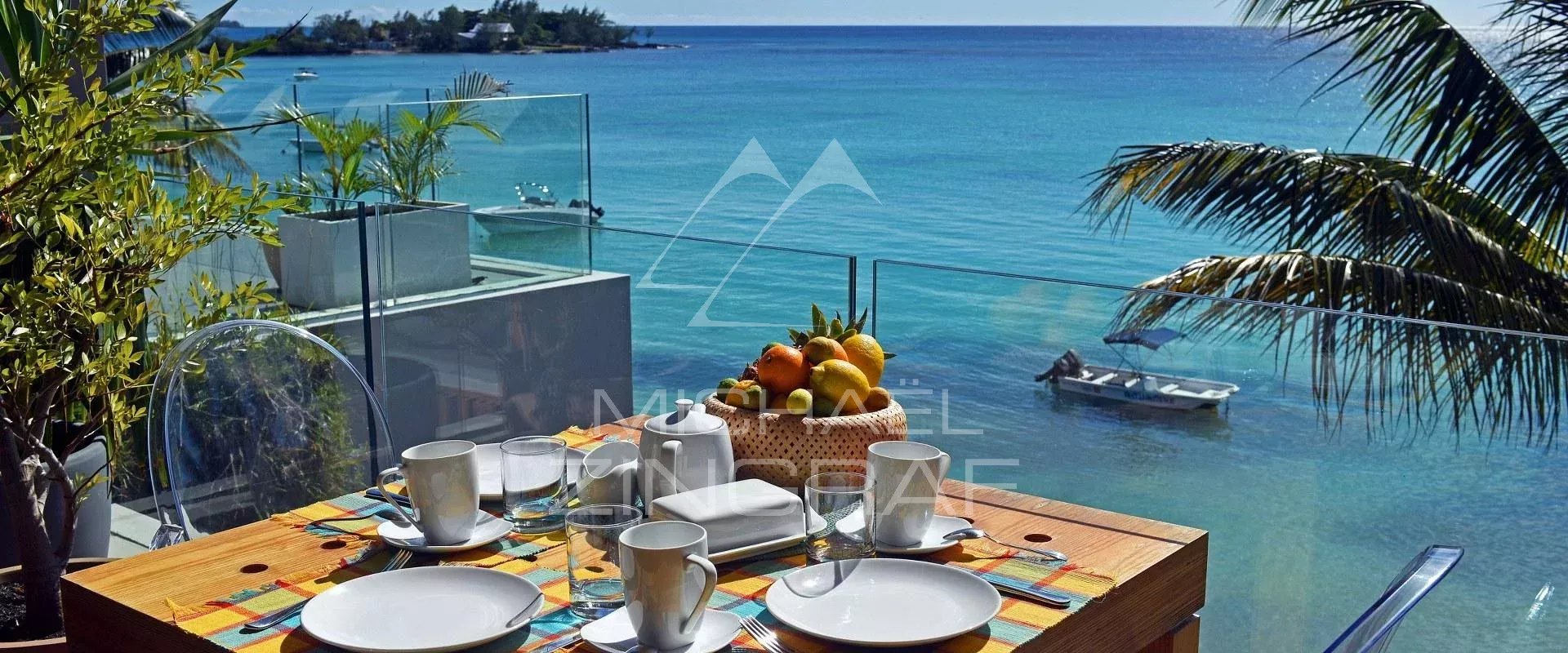 Terrace with sea view in Pereybere Terrace of an apartment with sea view, table set for breakfast in Pereybere.