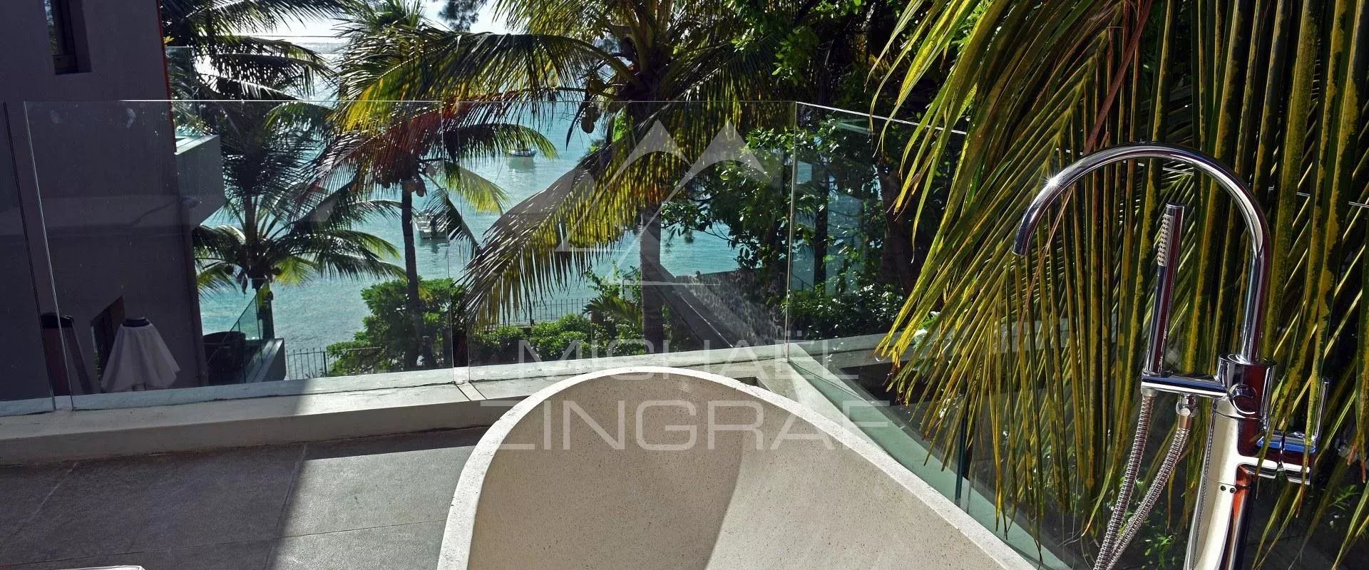 Terrace with sea view in Pereybere Terrace of an apartment with sea view in Pereybere, surrounded by palm trees.