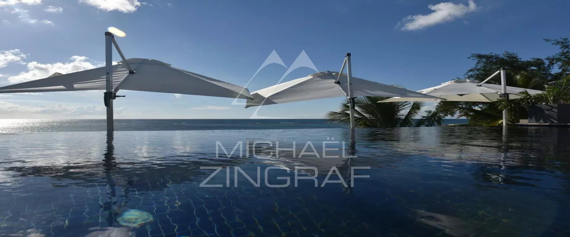 Infinity pool in Pereybere View of the infinity pool with parasols and sea in the background in Pereybere.