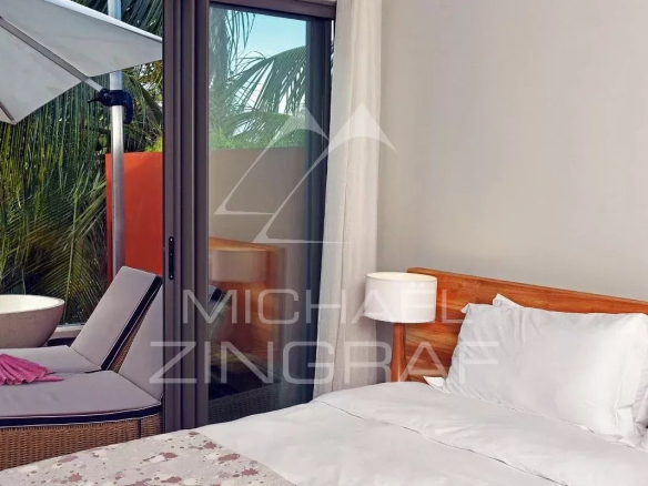 Room in an apartment with bed, armchairs and terrace, sea view in Pereybere.