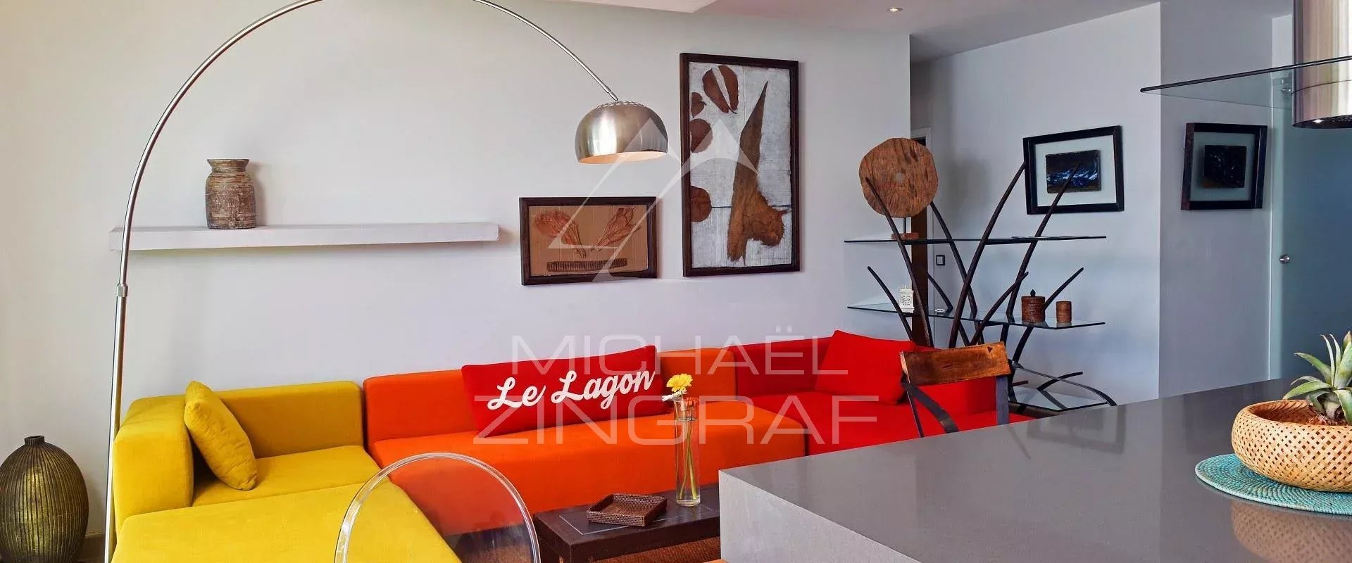 Elegant apartment in Pereybere Interior of a stylish apartment with a colorful living room and open kitchen in Pereybere.