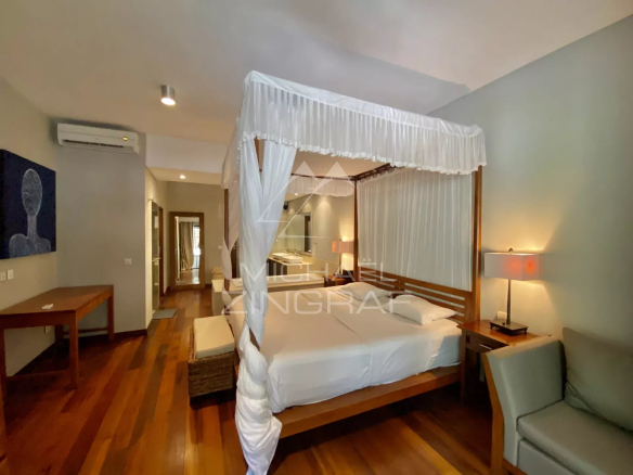 Chambre d'un appartement élégant avec lit à baldaquin et décoration moderne à Bain Bœuf.