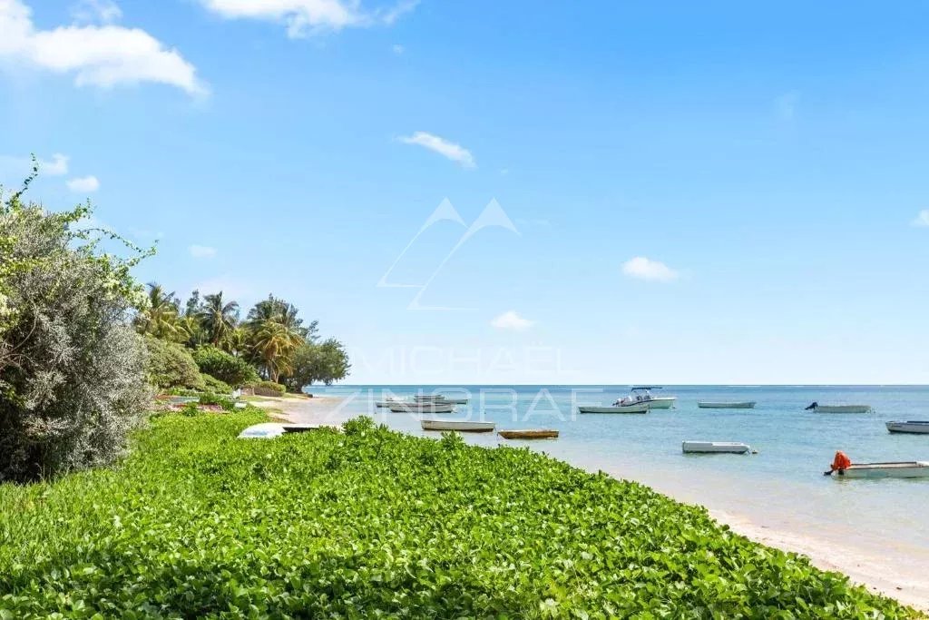 Plage de Bain Bœuf Plage de Bain Bœuf avec des bateaux et de la végétation en bord de mer.