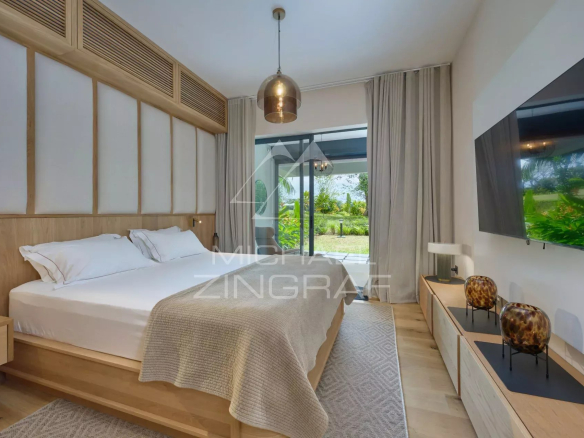 Apartment room with double bed and access to a private garden.