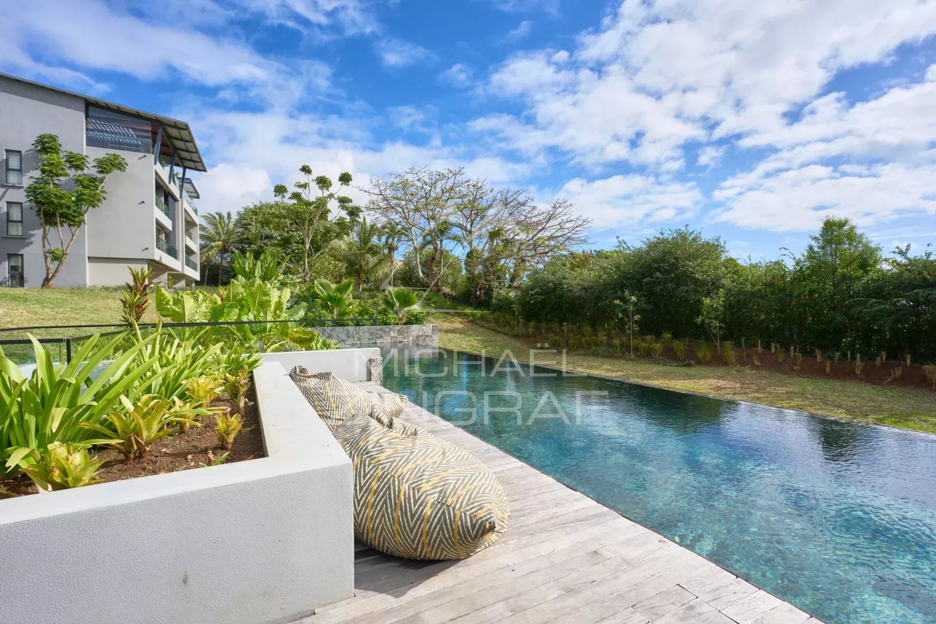 View of a private garden with swimming pool and relaxation area, apartment in Belle Vue Harel.