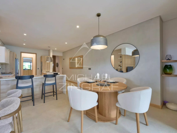 Interior of a modern apartment with dining room and open kitchen, elegant furniture.