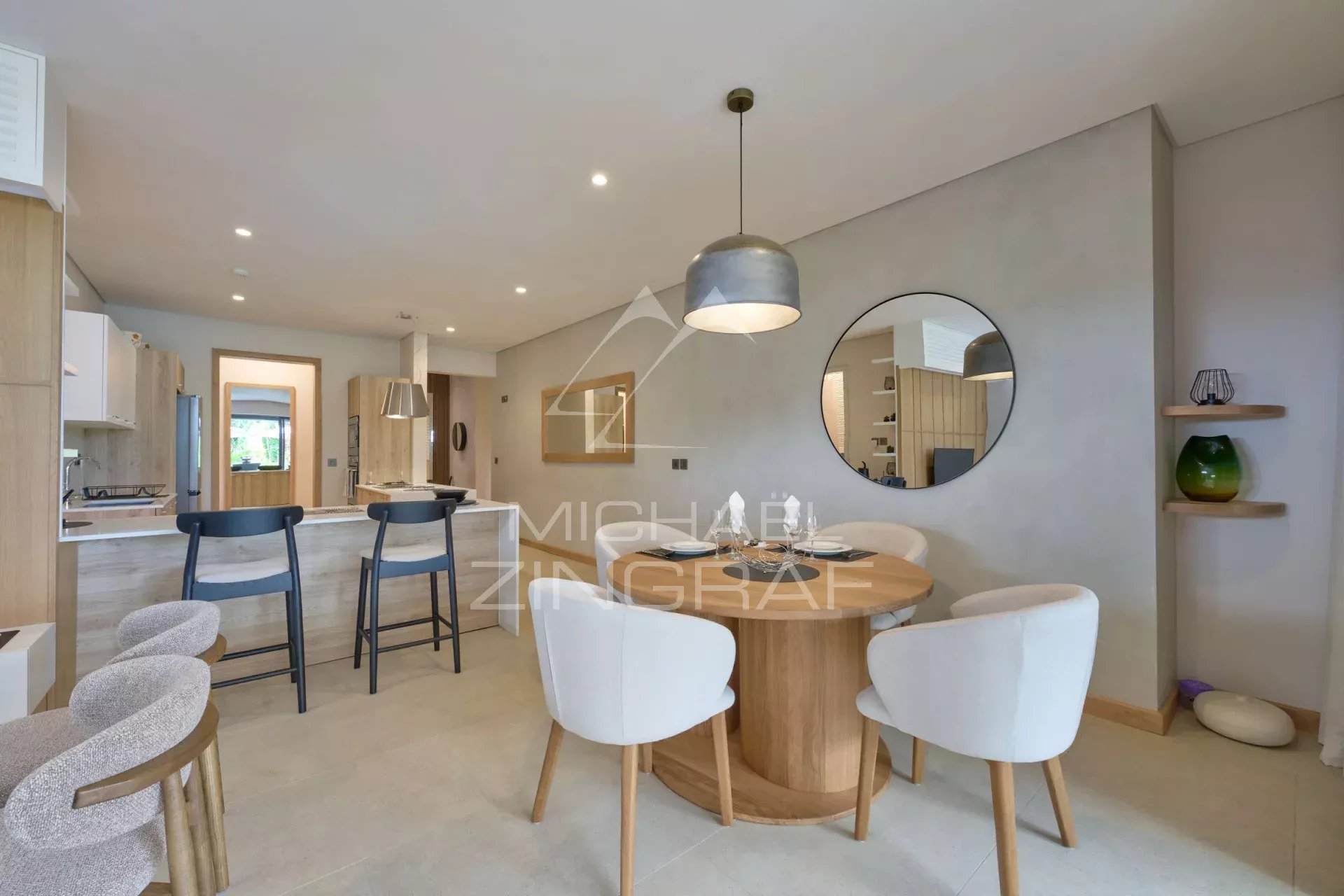 Interior of a modern apartment with dining room and open kitchen, elegant furniture.