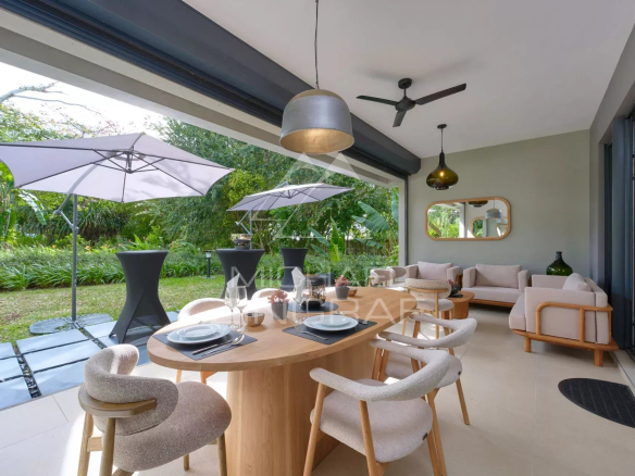 Interior of an elegant apartment with dining room and living room, opening onto a private garden.