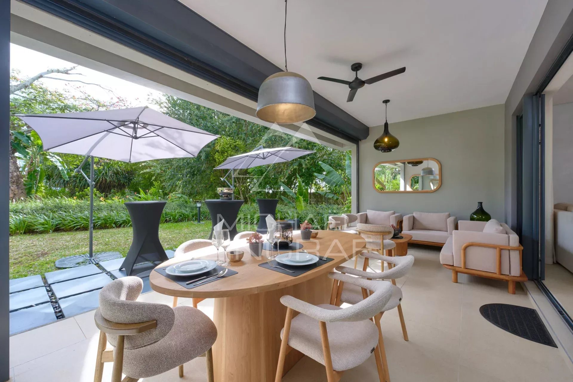 Interior of an elegant apartment with dining room and living room, opening onto a private garden.